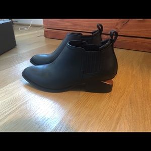 Black ankle boots with rose gold cutouts